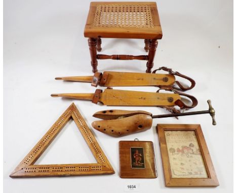 A turned wood stool, wooden skates, cribbage board and shoe stretcher 