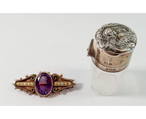 A silver and amethyst brooch (not hallmarked) and a silver mounted smelling salts bottle