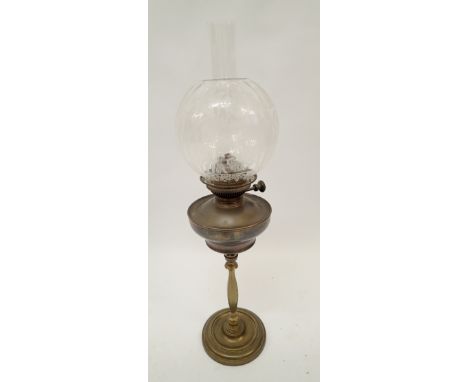A 19th century brass oil lamp with tall slender column and etched glass shade 