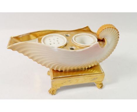 A 19th century shell form gilt and cream inkwell, 13cm tall, 19cm wide, chip to rim and wear to gilding, firing crack to one 