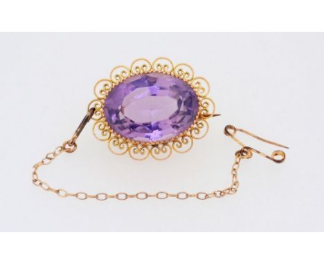 A 9 carat gold oval filigree mounted amethyst brooch, 2.5cm, boxed 