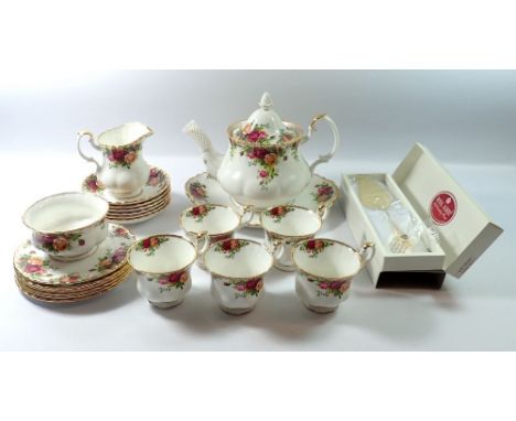 A Royal Albert Country Roses tea service comprising teapot, five cups and six saucers, milk jug, sugar bowl cake plate and ca