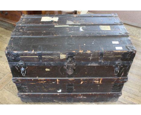 A vintage metal bound travelling trunk with red lined interior