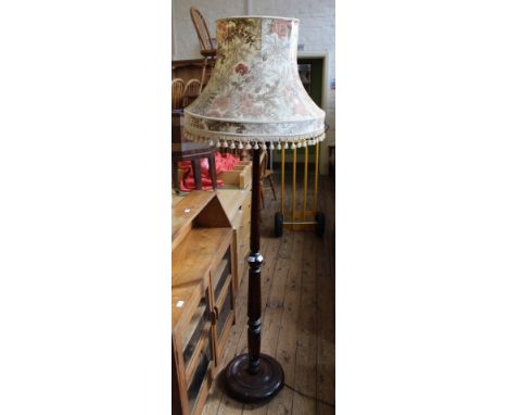 An Edwardian oak standard lamp