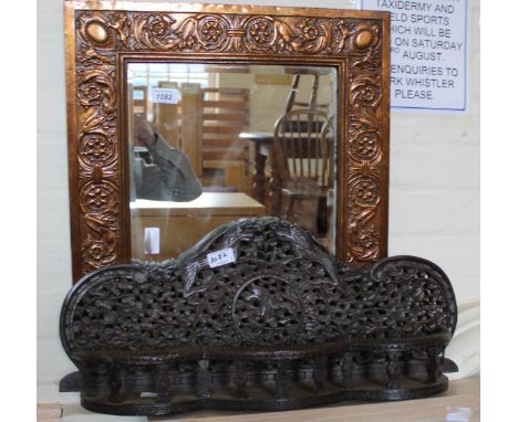 An Indian carved hardwood shelf and a copper framed mirror