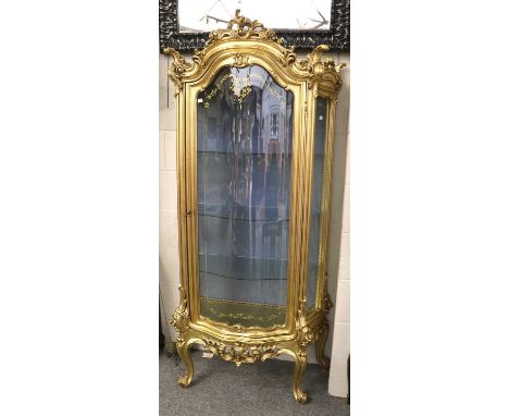 A French Style Reproduction Gilt Serpentine Fronted Vitrine, with scrolling acanthus leaf decoration, 90cm by 50cm by 184cm