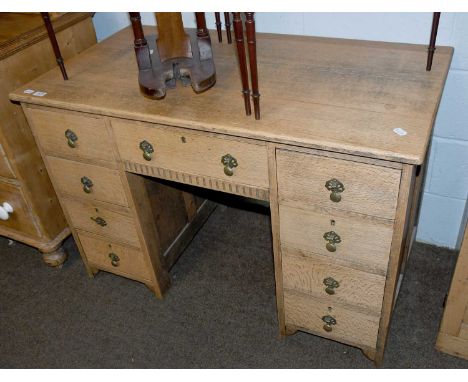 A Light Oak Kneehole Desk, early 20th century with brass handles, 114cm by 60cm by 76cm