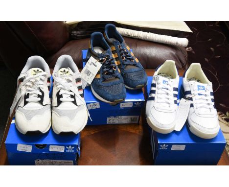 Three Pairs of Brand New Unworn Adidas Trainers, comprising a pair of Guam trainers in white leather with navy blue stripes a