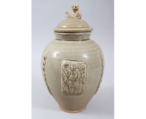 A CHINESE LONGQUAN CELADON CRACKLE GLAZE JAR &amp; COVER, with moulded panels of immortals, the lid with a moulded lion dog f