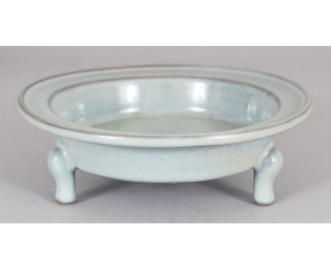 A CHINESE SONG STYLE RU WARE TRIPOD PORCELAIN CENSER, with a flanged rim, 15cm diameter.