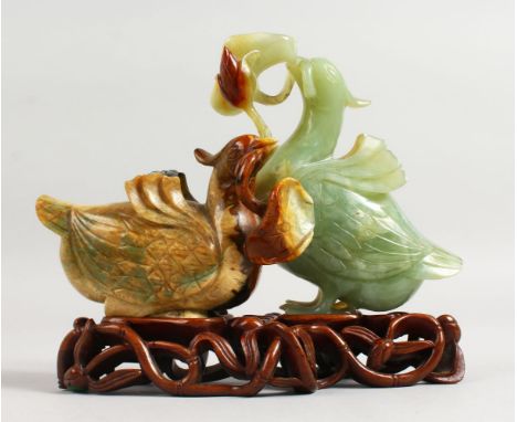 A GOOD 19TH CENTURY JADE GROUP OF TWO DUCKS on a pierced wooden stand. 7ins long.