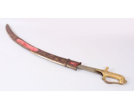 A FINE INDIAN SWORD with gilded handled and gold inlaid worked steel scabbard.