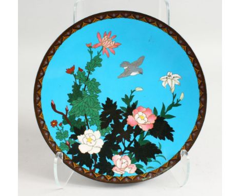 A 19TH CENTURY JAPANESE CLOISONNE ENAMEL DISH, blue ground with flowers and birds. 12ins diameter.