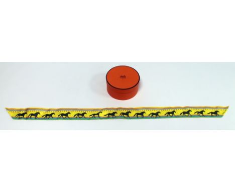 Hermes, Paris, narrow lady's silk neck tie decorated with horses on yellow ground, 84cm long, with box. Condition Report. Goo