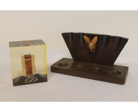 20th century mahogany pipe stand with stylised rabbit head made from a carved nut and bakelite 23cm wide; also a Perspex adve