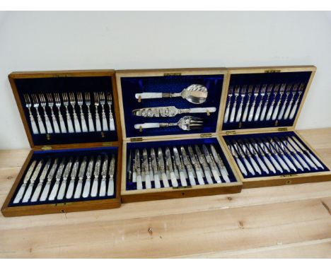 Three fruit knife and fork sets, e.p. blades on mother of pearl handles all in wood presentation cases.