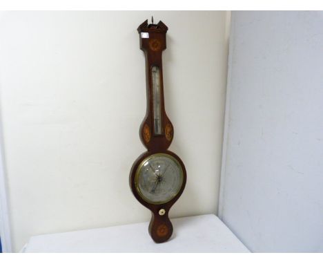 Mahogany wheel barometer by Higgins, Colchester with silvered scale, similarly inlaid.