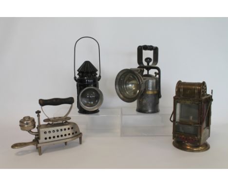 Crestella Engineering Co. "The Premier" carbide railway lamp, two others and "The Perfect" spirit iron on stand. (4).  