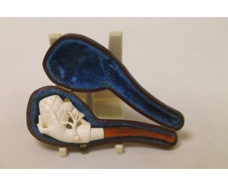 Late 19th century Meerschaum carved "Pine Cone in Hand" pipe with amber stem, as new, 10.5cm long, cased.