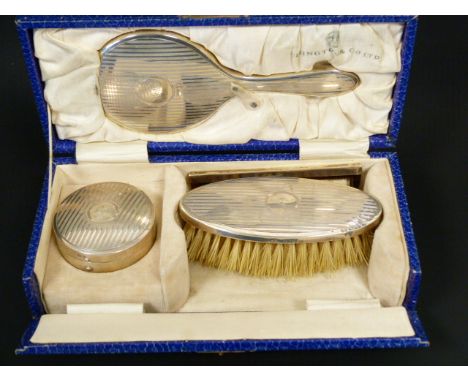 Child's silver hair brush, mirror, comb and trinket box, cased.