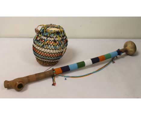 Early to mid 20th century African beaded Ostrich egg, 17cm high and an African beaded pipe with pottery bowl and gourd mouthp