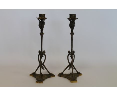 Pair of 19th century Continental candlesticks moulded with Pelicans and Egyptian mask heads, tripod base, silvered and gilt f