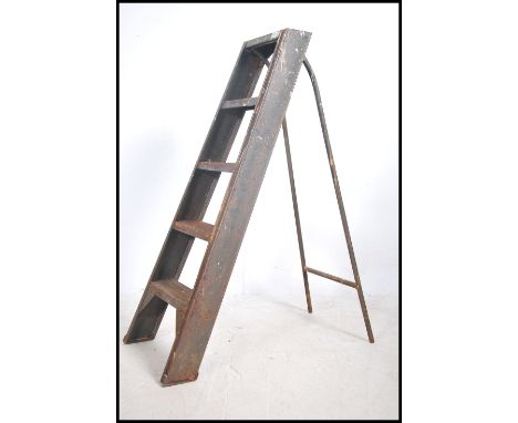 A mid century Industrial enamel painted metal ladder of A-frame style that folds. Finished in a British military green enamel