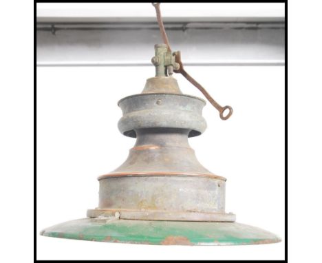 An early 20th century Industrial enamel painted two two factory light in green and white set to the original copper cylindric