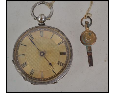 An early 20th century silver key wound pocket fob watch having an engine turned centre dial with roman numerals.