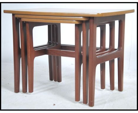 A vintage teak wood triple table set of tables.&nbsp;Measures height 53cm x width 71cm x depth 48cm.
