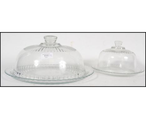 A near pair ( differing sizes ) of vintage 20th century glass cloche's with glass liners. The largest measures 33cm wide.