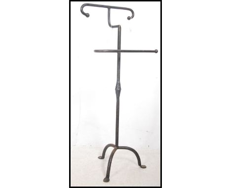 A 19th century cast iron gentlemans valet - vanity stand being raised on a splayed tripod base with stretchers and finials at