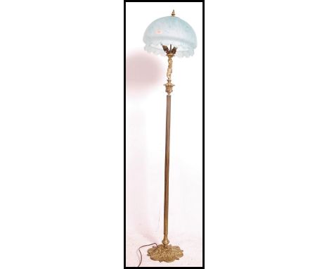 A stunning early 20th century brass standard / floor lamp having a reeded&nbsp;column upright surmounted with a putti raising