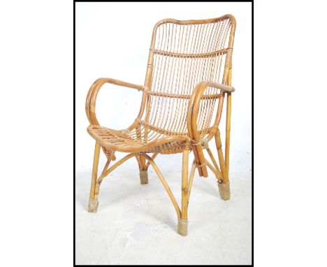 A vintage 20th century&nbsp;bamboo fan back ' tropics ' lattice work arm chair.&nbsp;Measures height 92cm x width 57cm x dept