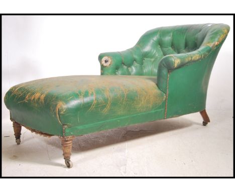 A Victorian mahogany and leather chaise longue armchair in the manner of Howard &amp; Sons, London. The chaise day bed with t