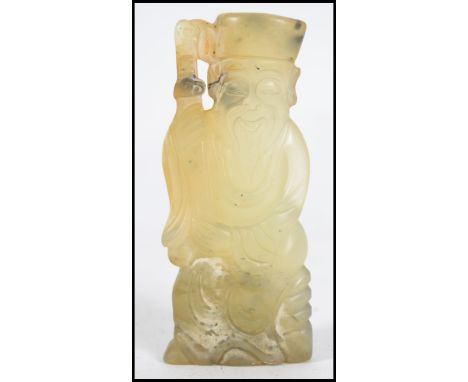 A Chinese &nbsp;jade carved sculpture of an old man / village elder holding a scroll. Carved from a singular piece of jade. M
