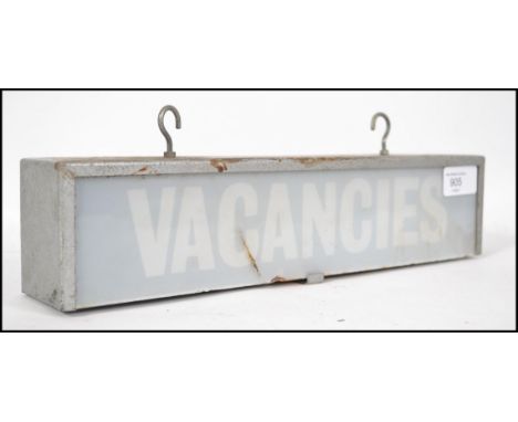 A vintage / retro double sided illuminated VACANCIES advertising sign. The sign with attachment hooks to the top of the metal