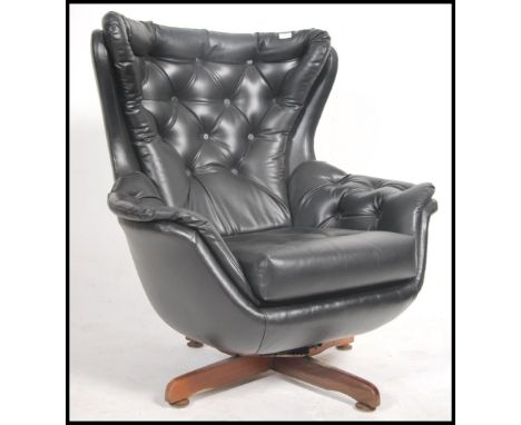 A stunning 1960's &nbsp;retro batwing swivel armchair / chair . The chair consists of a large faux leather batwing &nbsp;shap