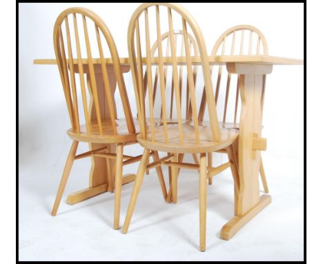 A set of 4 Ercol style hoop back dining chairs being raised on turned legs with saddle seats together with a light oak refect