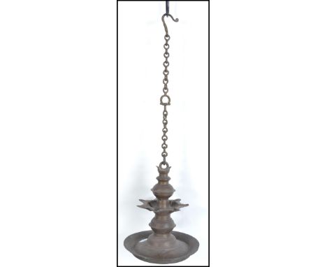 A 19th century, possibly earlier Indian bronze butter lamp. The lamp with hanging chain over large dish
