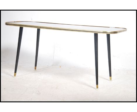 A vintage / retro mid century 1960's oblong coffee table having a Pagoda design to the top being raised on tapering legs.