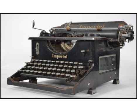 An early 20th century typewriter by Imperial. The enamel painted metal with original notation for Imperial with gilded notati