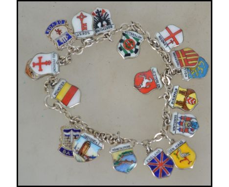 A &nbsp;vintage silver bracelet strung with enamelled place name shields. Measures approx 20cms. Total weight approx 26g.