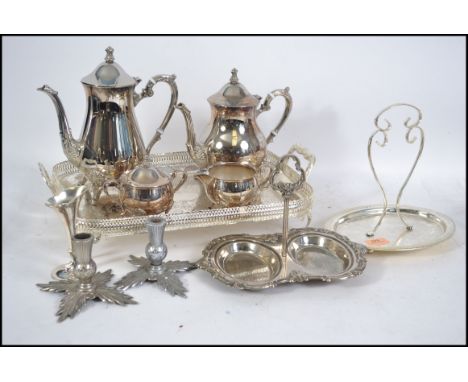 A silver plate tea and coffee service having a gallery tray along with a pair of Art Nouveau silver plated candle sticks and 
