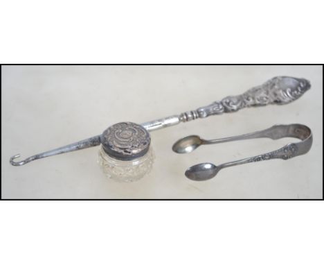 A silver hallmarked pair of sugar nips Birmingham 1907 by IG, Together with a silver button hook and silver and glass pot, bo
