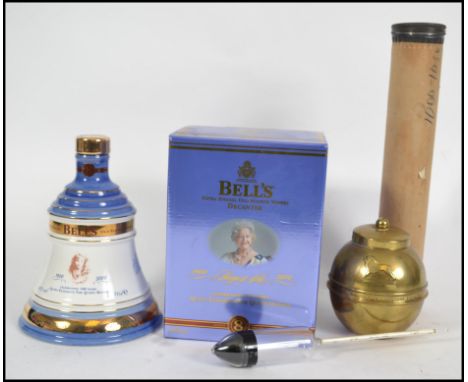 A commemorative boxed Bells Whisky commemorating the Queen Mum's 100th birthday together with a Lipton Brass tea caddy and a 