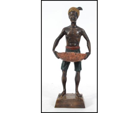 A cold painted bronze of a Blackamoor in an upright position in the manner of Bergman. Measures 28cm high.