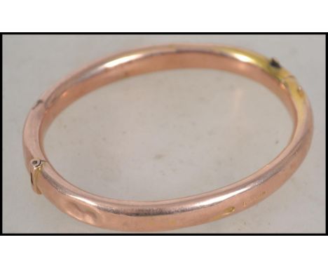 A hallmarked 9ct gold slave bangle bracelet having a hidden clasp. Weighs 7.3 grams and measures 7.5cms wide. Hallmarked to o