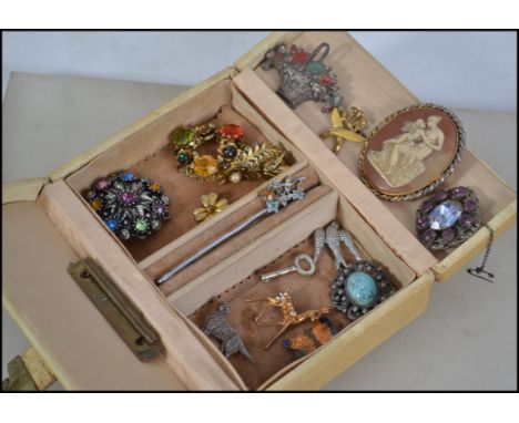 A collection of vintage brooch pins to include rhinestone and enamel set.