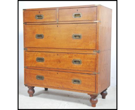 A 19th century Army And Navy teak wood and brass bound chest of drawers. The chest, in two parts with two short and three lon